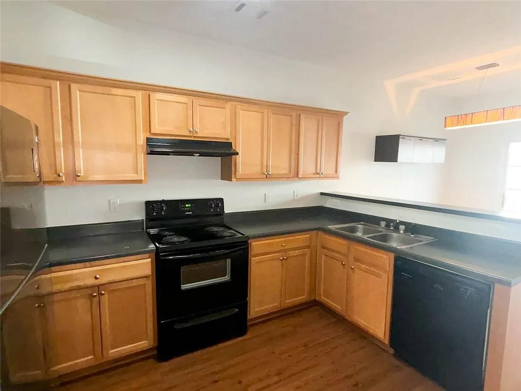 1493 Ashley Way Atlanta, GA 30344 - Photo 4 of 10 a kitchen with granite countertop wooden cabinets and a stove top oven