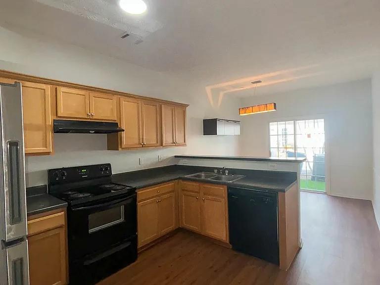 1493 Ashley Way Atlanta, GA 30344 - Photo 5 of 10 a kitchen with granite countertop a sink cabinets and stainless steel appliances