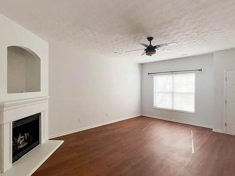 1493 Ashley Way Atlanta, GA 30344 - Photo 8 of 10 a view of empty room with a fireplace and wooden floor