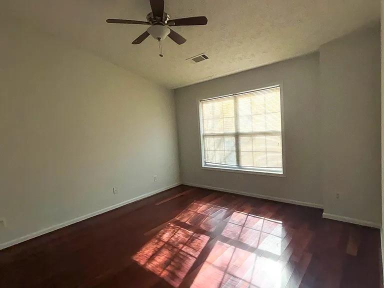 1493 Ashley Way Atlanta, GA 30344 - Photo 9 of 10 a view of empty room with wooden floor and fan