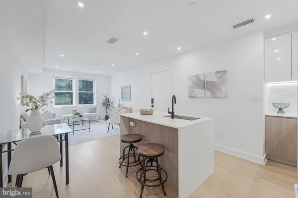 a living room with furniture a dining table and chairs
