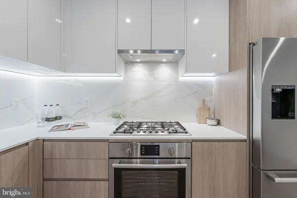 a kitchen with a stove and a refrigerator
