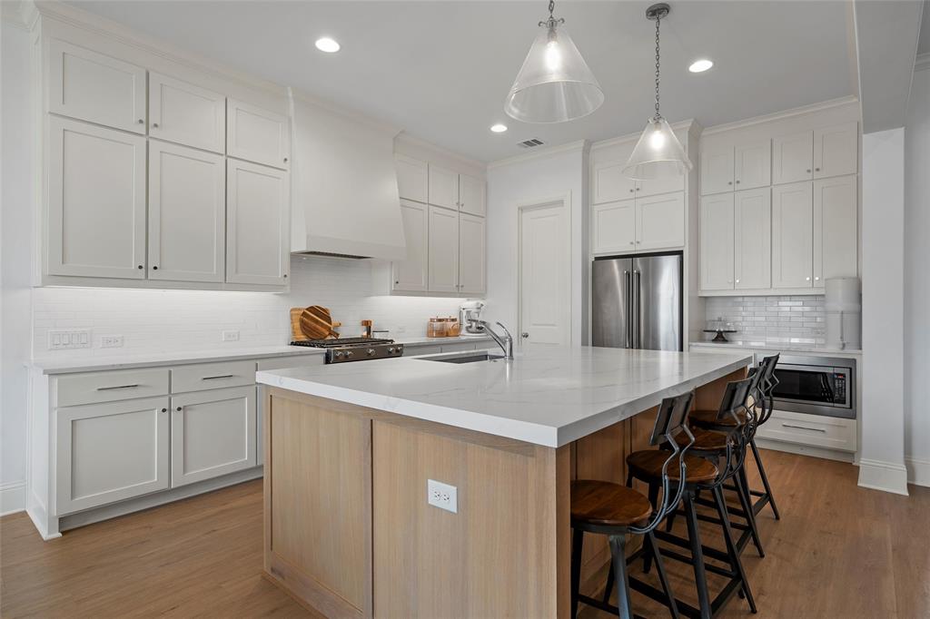 12014 Kenai Circle Woodway, TX 76712 - Photo 11 of 39 a kitchen with a white cabinets and chairs