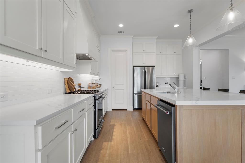 12014 Kenai Circle Woodway, TX 76712 - Photo 12 of 39 a kitchen with granite countertop a sink stove and cabinets