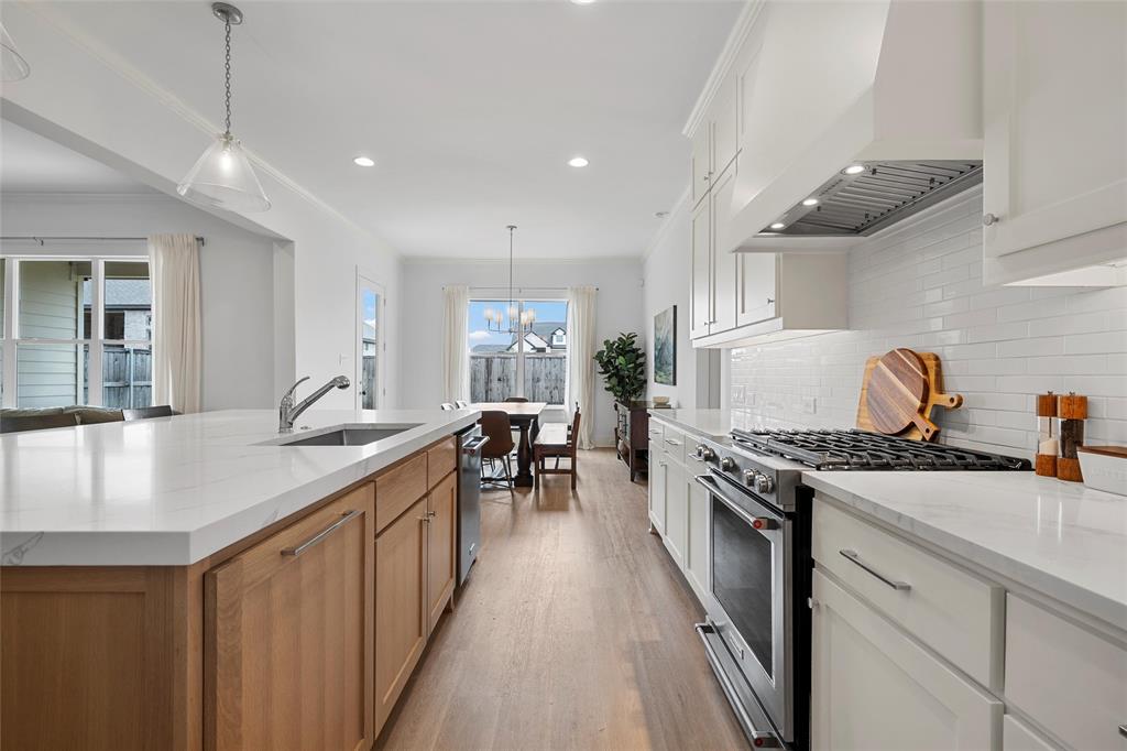 12014 Kenai Circle Woodway, TX 76712 - Photo 13 of 39 a kitchen with sink stove and cabinets