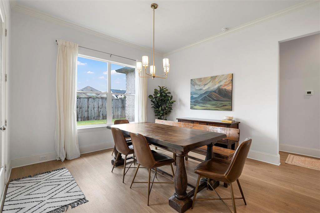12014 Kenai Circle Woodway, TX 76712 - Photo 15 of 39 a view of a dining room with furniture window and wooden floor