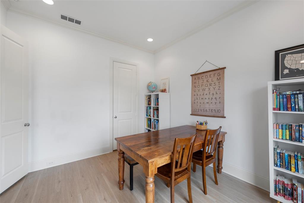 12014 Kenai Circle Woodway, TX 76712 - Photo 26 of 39 a view of a dining room with furniture and a book shelf