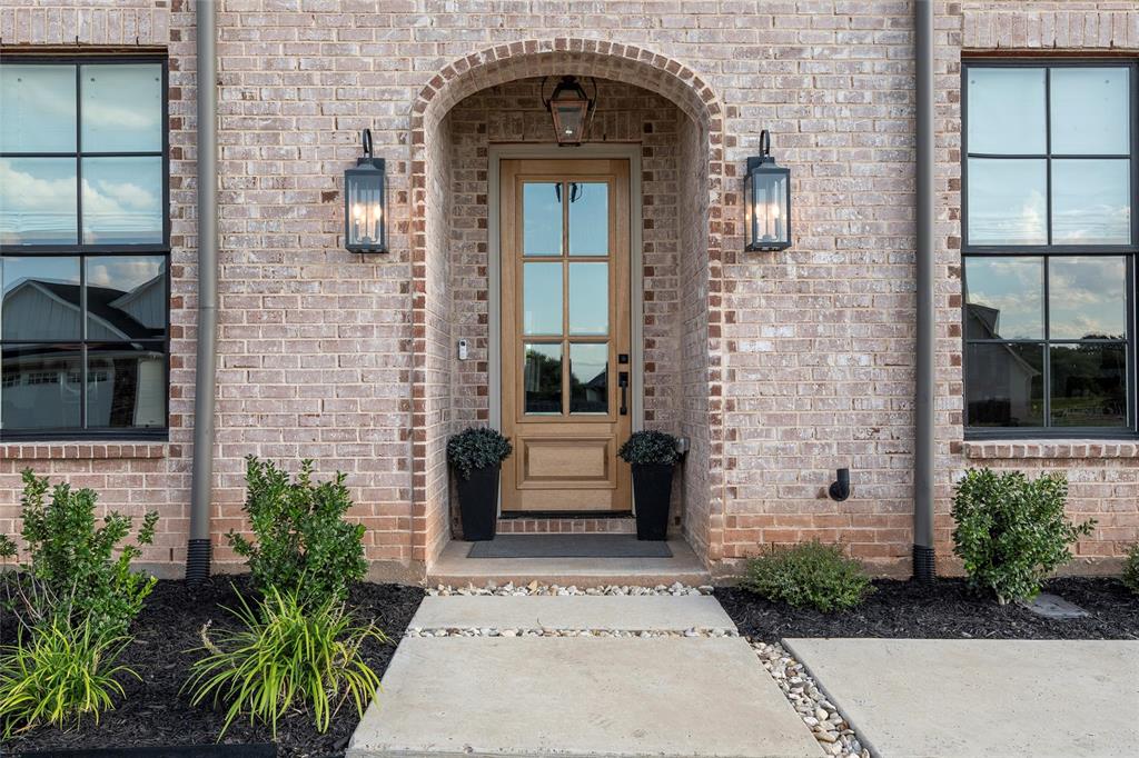 12014 Kenai Circle Woodway, TX 76712 - Photo 3 of 39 a front view of a house with a garden