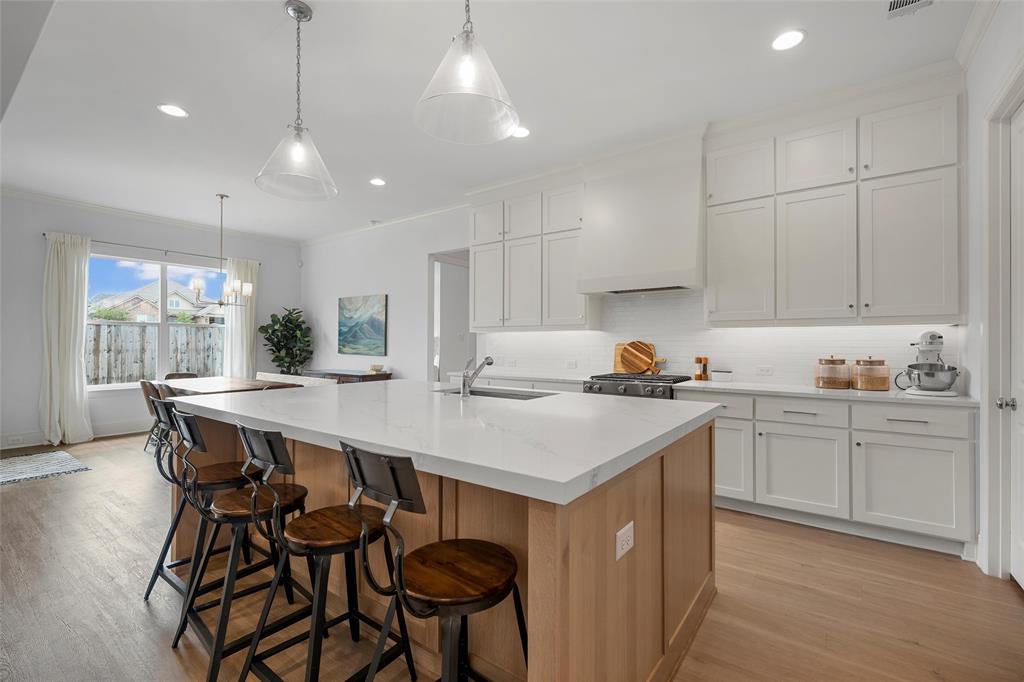 12014 Kenai Circle Woodway, TX 76712 - Photo 10 of 39 a kitchen with a dining table chairs sink and cabinets