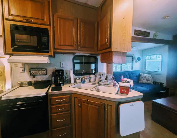 a kitchen with a sink stove and cabinets