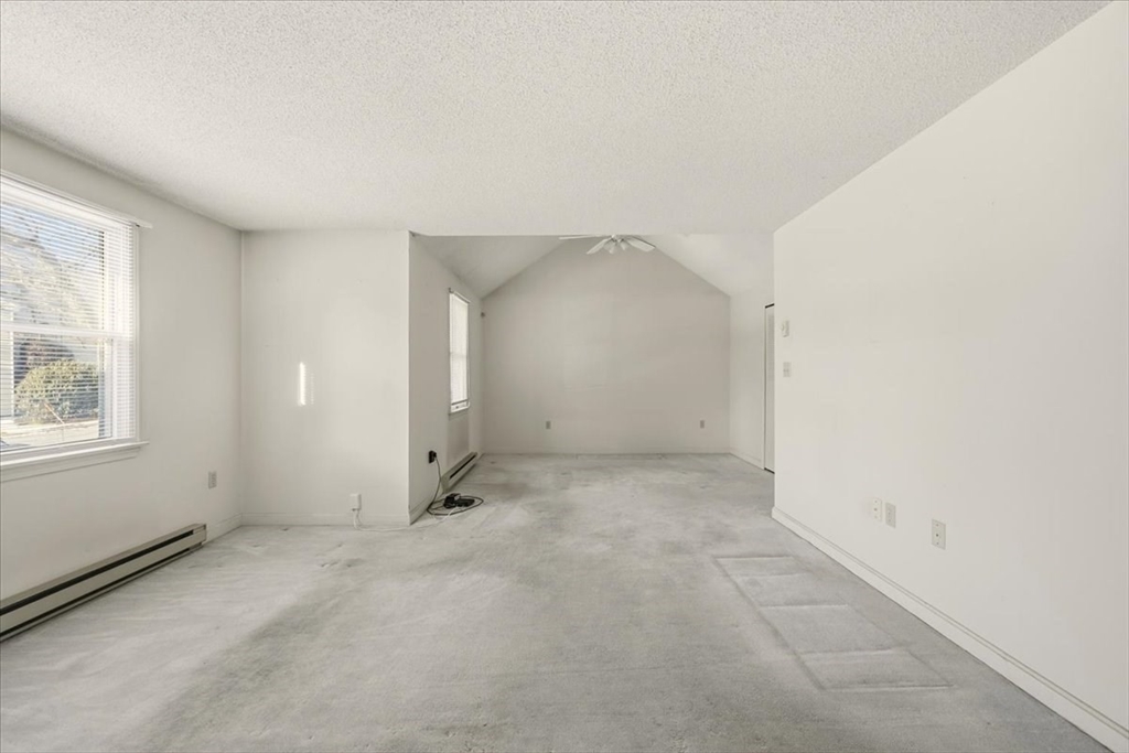 87 Victoria Heights Road, Unit 87 Boston, MA 02136 - Photo 10 of 32 an empty room with windows