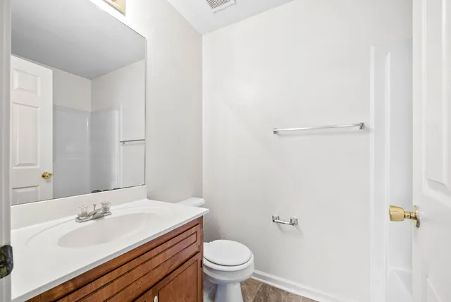 a bathroom with a sink toilet and vanity