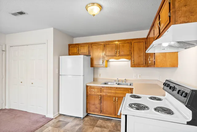 a kitchen with a refrigerator a stove a washer and dryer