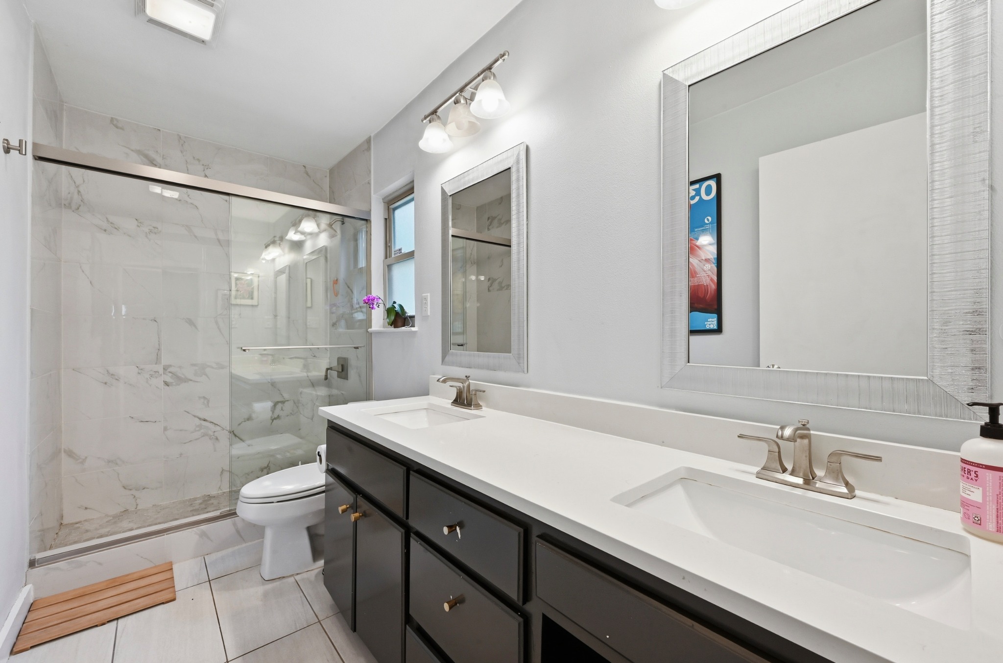 2509 Redleaf Lane Austin, TX 78745 - Photo 12 of 28 Double vanity with integrated sinks, brushed nickel faucets, and matching framed mirrors