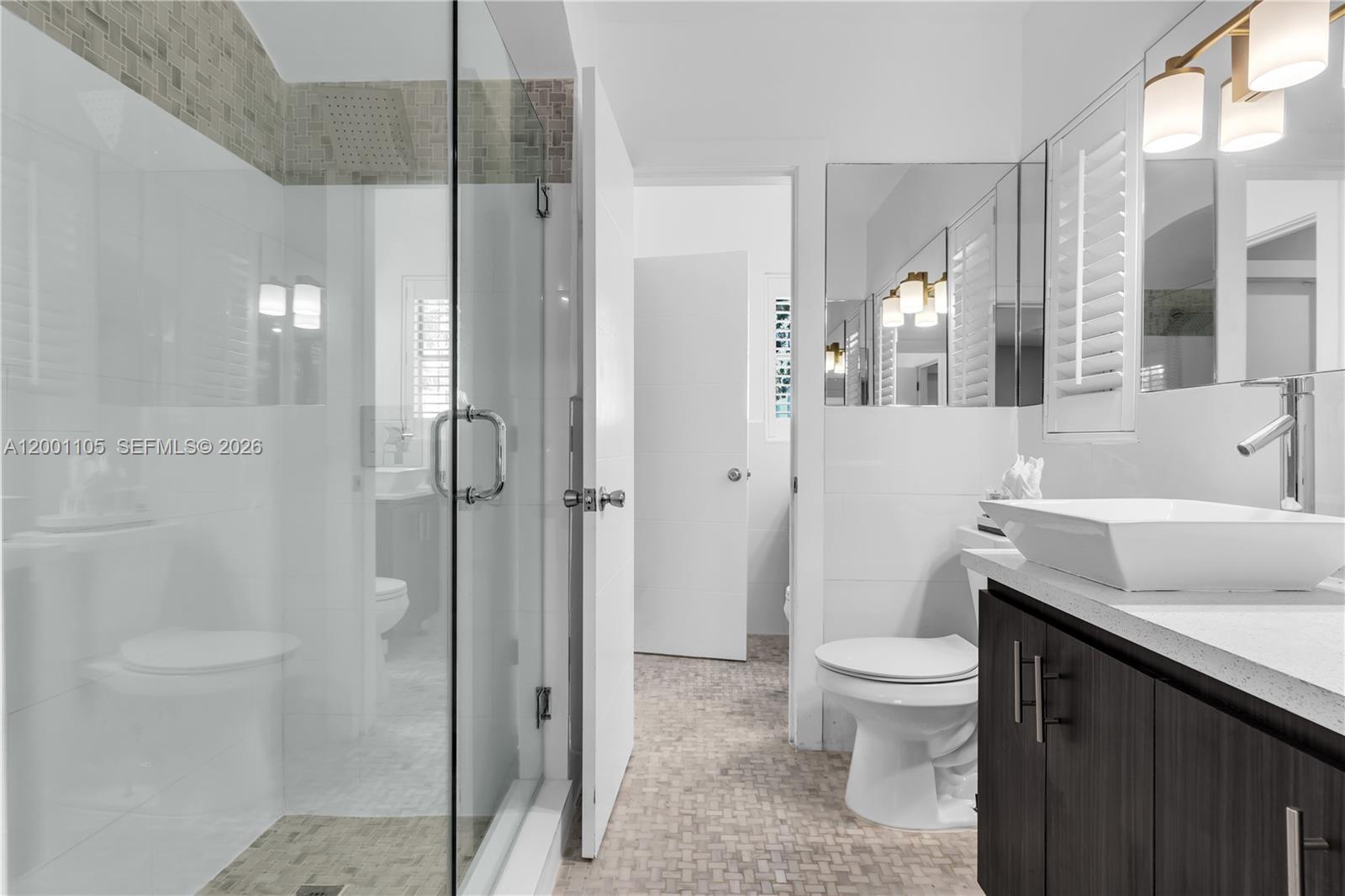 8101 Harding Avenue Miami Beach, FL 33141 - Photo 13 of 34 a bathroom with a sink a toilet and shower