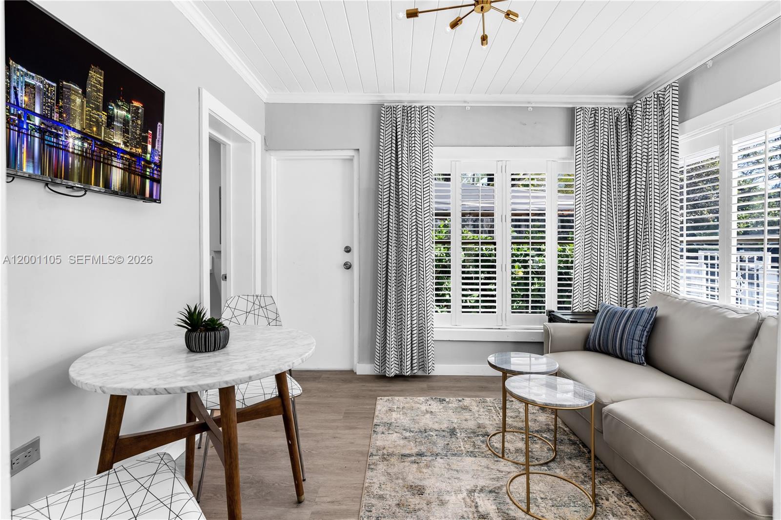 8101 Harding Avenue Miami Beach, FL 33141 - Photo 16 of 34 a living room with furniture and a window