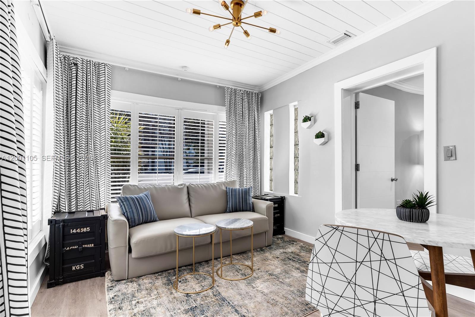 8101 Harding Avenue Miami Beach, FL 33141 - Photo 17 of 34 a living room with furniture and a window