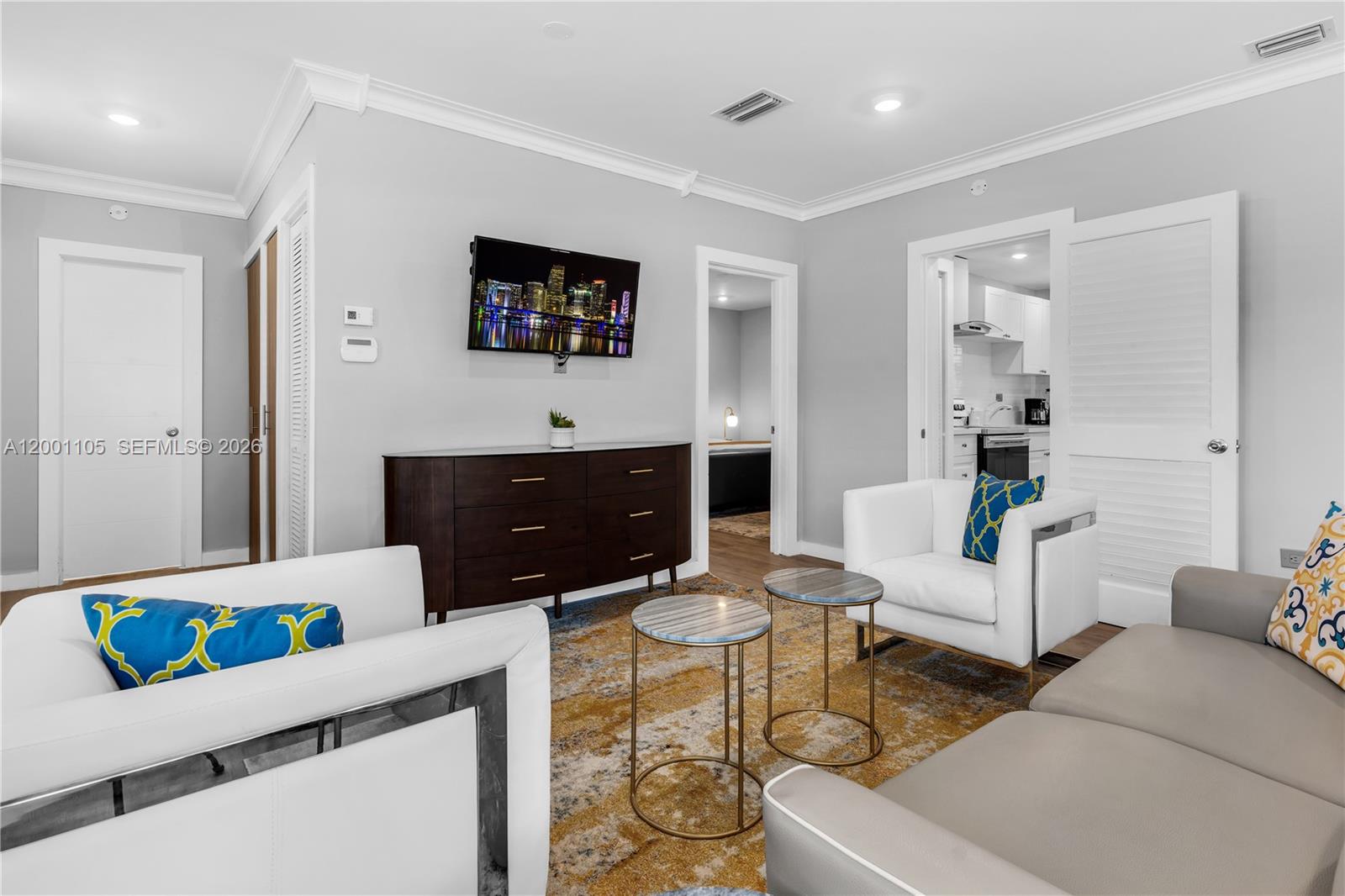 8101 Harding Avenue Miami Beach, FL 33141 - Photo 2 of 34 a living room with furniture and a flat screen tv