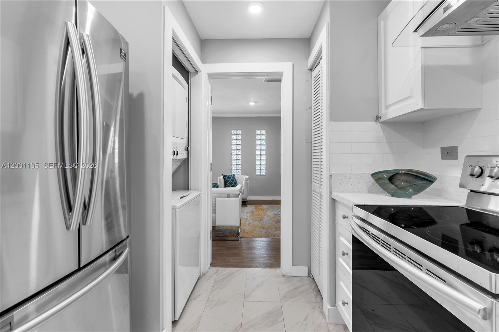 8101 Harding Avenue Miami Beach, FL 33141 - Photo 7 of 34 a kitchen with stainless steel appliances granite countertop a refrigerator and a stove
