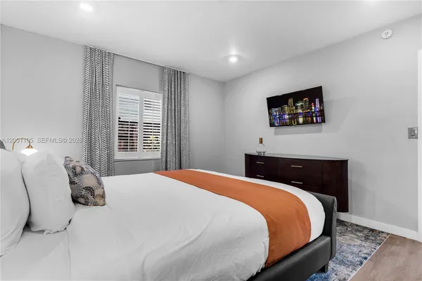 a bedroom with a bed and a lamp