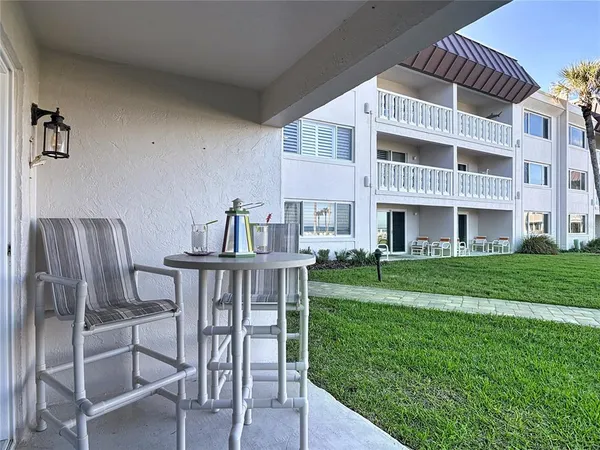 a outdoor living space with a couch and chairs