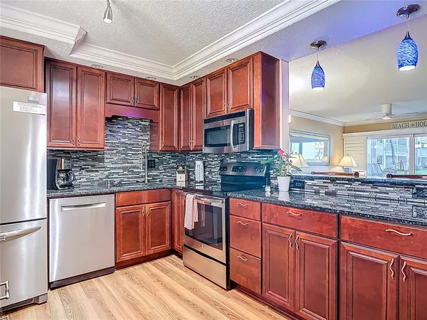 a kitchen with stainless steel appliances granite countertop a sink and cabinets
