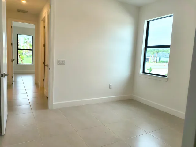 an empty room with windows and closet