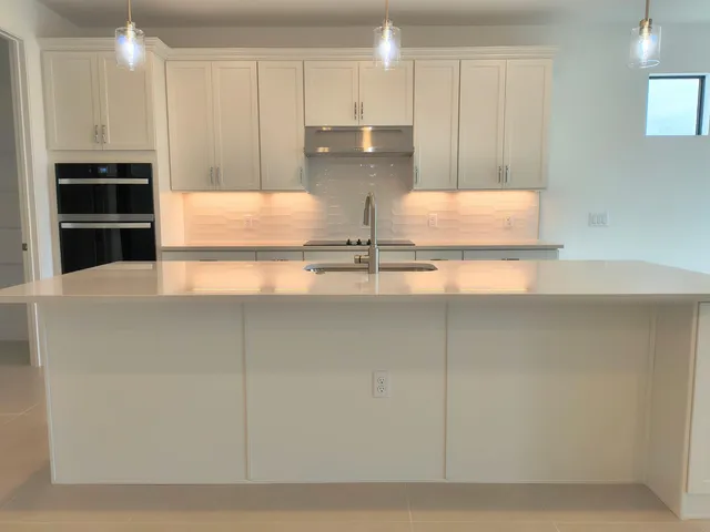 a view of kitchen with stainless steel appliances cabinets