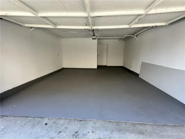 a view of a fountain in front of brick house