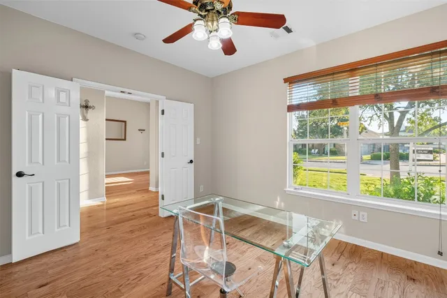 a living room with hardwood floor and a window