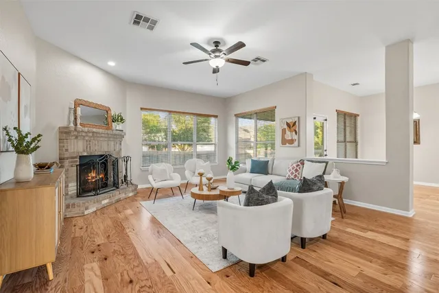 a living room with furniture fireplace and a large window