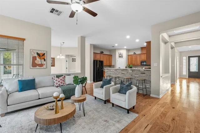 a living room with furniture and a wooden floor