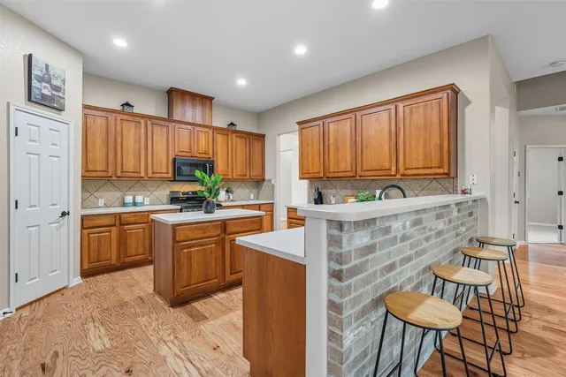 a kitchen with cabinets and appliances