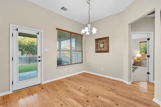 a kitchen with stainless steel appliances granite countertop a stove a sink dishwasher and a microwave oven with white cabinets