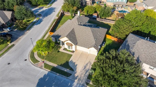 an aerial view of a house with swimming pool and outdoor seating