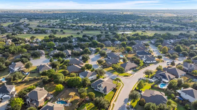 an aerial view of a house with a garden and trees