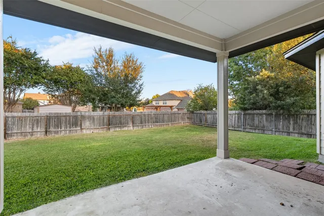 a view of a back yard from a porch