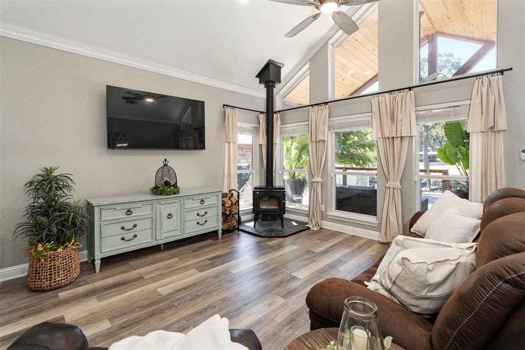 127 Rueda Encina Street Gun Barrel City, TX 75156 - Photo 18 of 39 a living room with furniture a flat screen tv and a floor to ceiling window