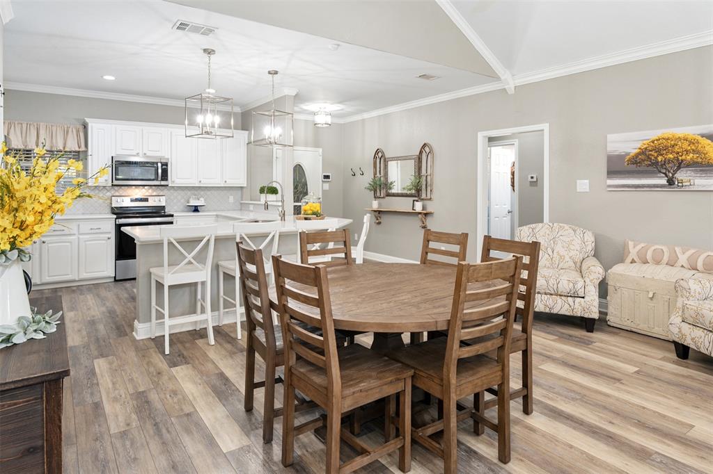 127 Rueda Encina Street Gun Barrel City, TX 75156 - Photo 20 of 39 a view of a dining room with furniture and wooden floor