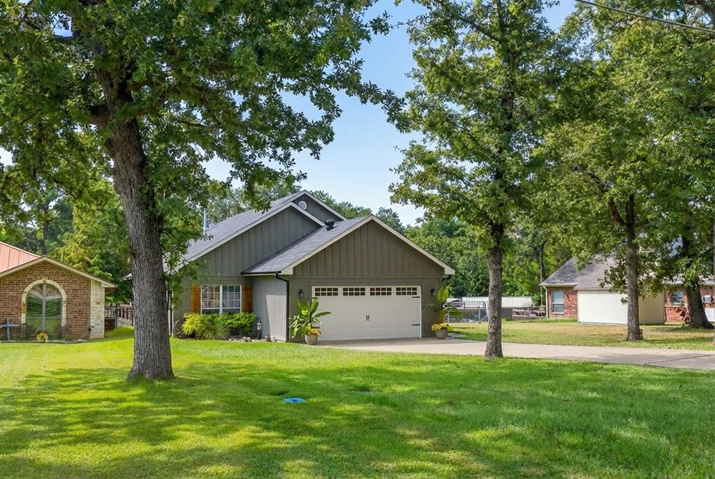 127 Rueda Encina Street Gun Barrel City, TX 75156 - Photo 2 of 39 a front view of a house with a yard and trees