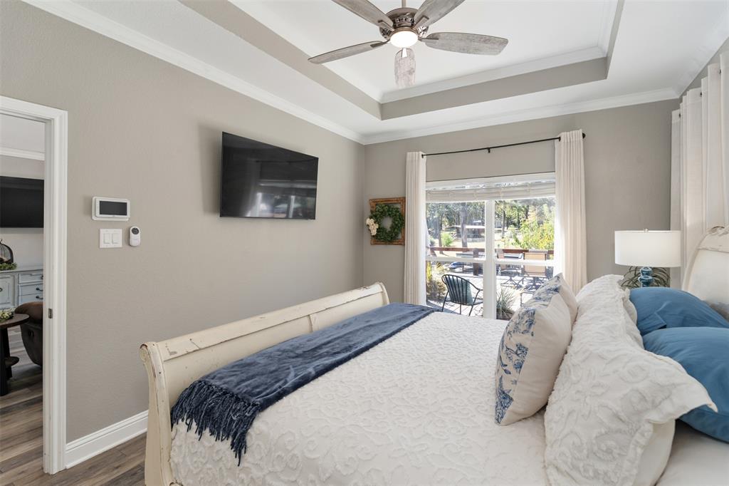 127 Rueda Encina Street Gun Barrel City, TX 75156 - Photo 22 of 39 a bedroom with a large bed and a window