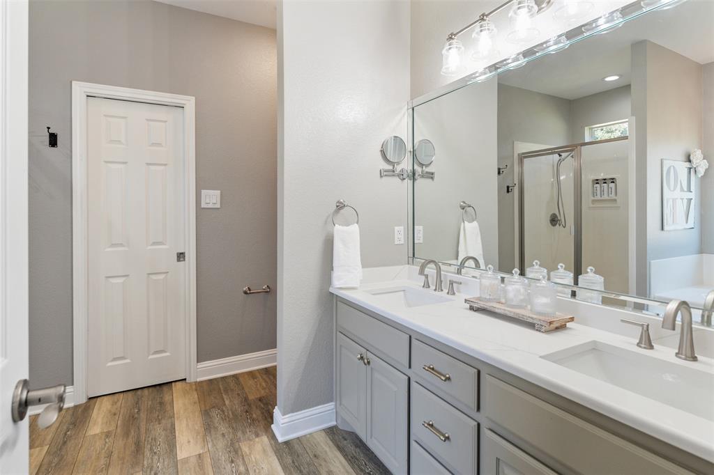 127 Rueda Encina Street Gun Barrel City, TX 75156 - Photo 26 of 39 a bathroom with a double vanity sink and mirror