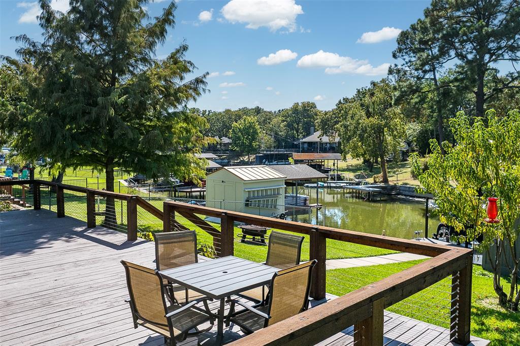 127 Rueda Encina Street Gun Barrel City, TX 75156 - Photo 35 of 39 a view of a chairs and table on the wooden deck
