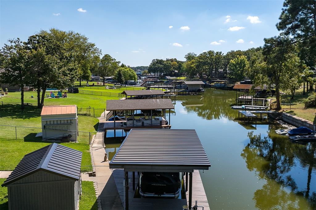 127 Rueda Encina Street Gun Barrel City, TX 75156 - Photo 39 of 39 a view of a chairs and table on the deck near a lake