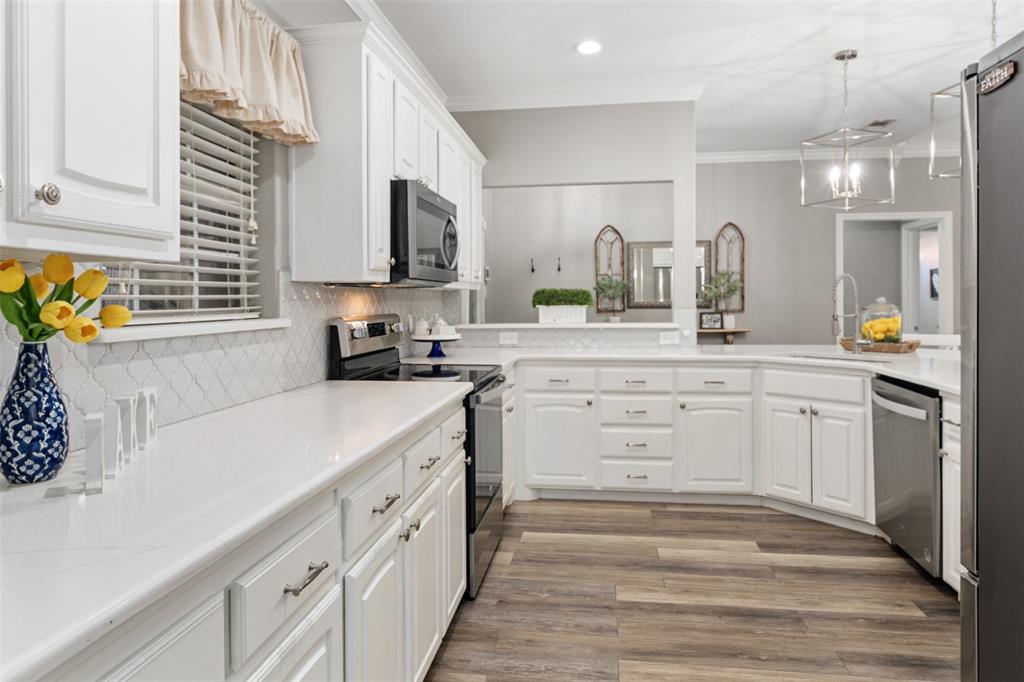 127 Rueda Encina Street Gun Barrel City, TX 75156 - Photo 10 of 39 a kitchen with white cabinets and appliances