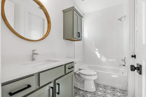 a bathroom with a sink toilet and shower