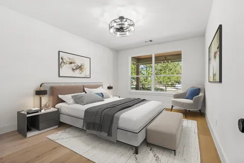 a bedroom with a bed and a large window