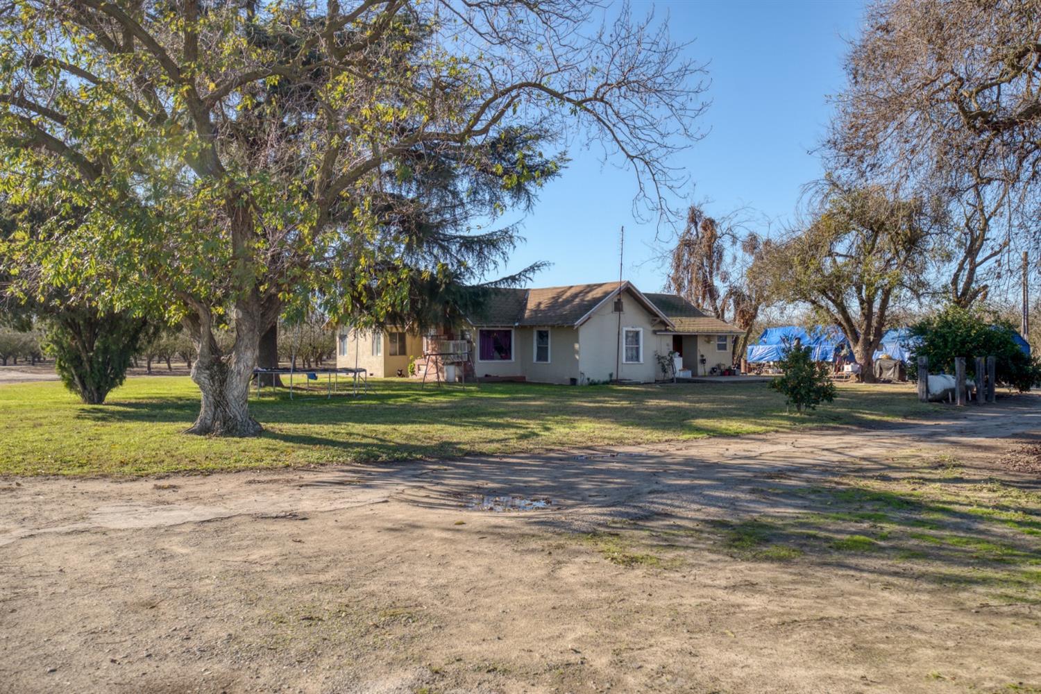 5942 Roeding Road Hughson, CA 95326 - Photo 1 of 1 a view of big house with yard and trees