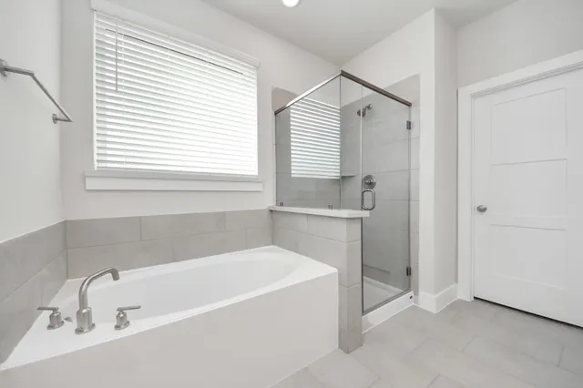 a white bath tub sitting under a bathroom