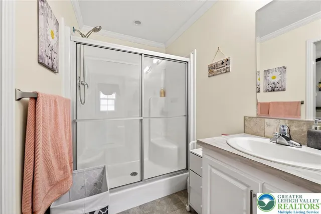 a bathroom with a shower sink and mirror